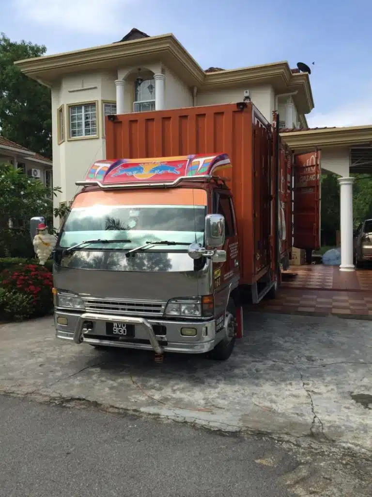 Professional movers handling furniture in Malaysia